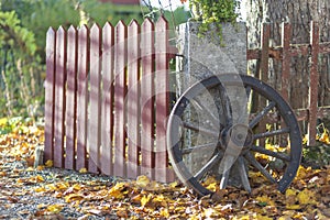 An old wagon wheel in fall