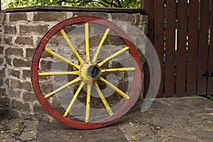 Old wagon wheel with metal rim leaning