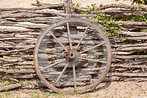 Old wagon wheel on the wooden fence