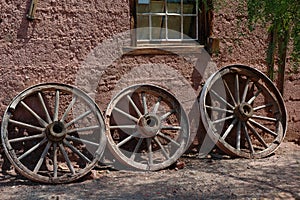Old wagon wheels in front of a house in Calico