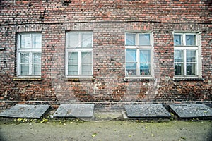 Old wall of abandoned house with windows closed