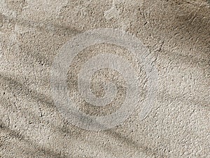 An old wall with abstract thin shadows on it. Cement surface close-up. Grunge concrete texture, minimal background.