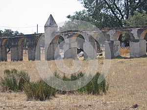 Old wall with arcs in the countryside of the Alentejo in Portugal.