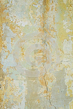 Old wall for texture or background, rough aged surface, remnants of peeling plaster, crack in the grunge-style wall
