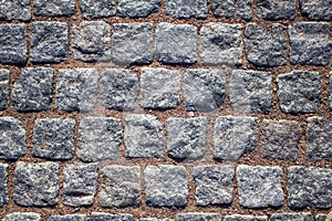 Old wall of blue gray square stone bricks with red cement. rough surface texture