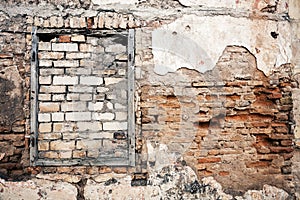 Old wall with boarded up window