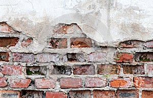 Old wall with brickwork under plaster