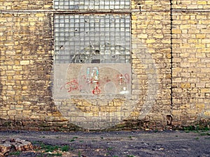 Old wall of a building brick coquina, broken glass