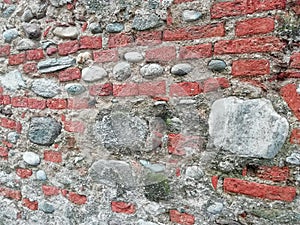 Old wall built of stone and red brick background