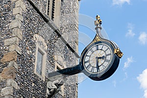 Old wall clock downtown in Canterbury city, England