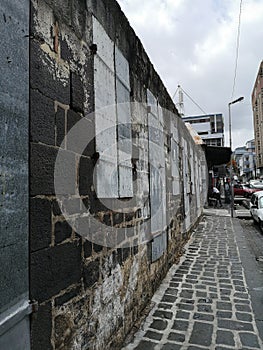 Old wall and cobblestone pavement in Port Louis, capital of Mauritius.