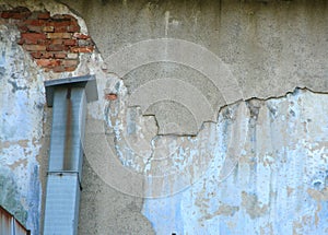 Old wall with damadged plaster and air vent