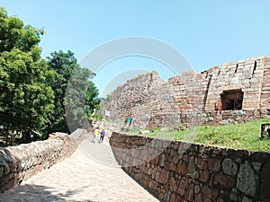 The old wall of the famous Tughlaqabad fort and its entry gate of Delhi, the capital of India photo