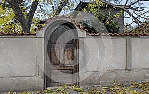 Old wall and front door covered with tile