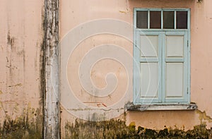 Old wall with green window
