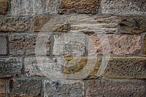 Old wall of a historical building with different colored stones