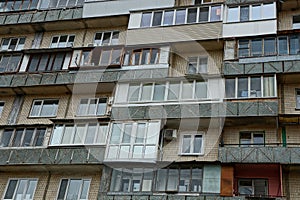 The old wall of the house with balconies and windows