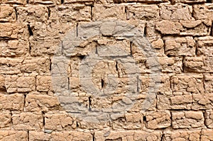 The old wall of a house built of clay bricks.