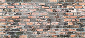 Old wall made of bricks in layers, brown-orange texture, brick wall pattern for the background.