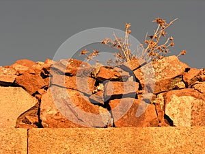 Old wall made of granite stones c