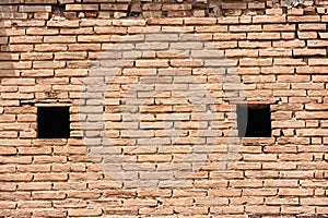 Wall of clay bricks and windows