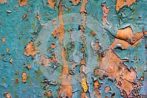 Old wall with orange and blue paint peeling off. background or texture