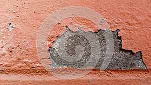 Old wall paint peeling off, making small sheets