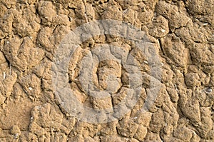 Old wall plastered with mud closeup