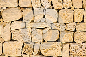 Old wall of porous sand stone bricks, close-up