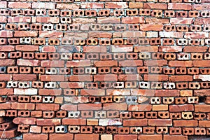 Old wall of red briks tiled background, regular block texture