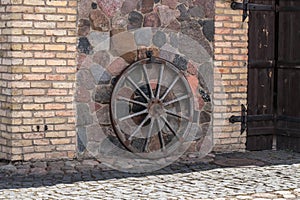 Old wall of a rustic barn made of chipped stone. Fragment.