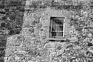 Old wall and a small barred window