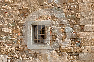 Old wall with a small window