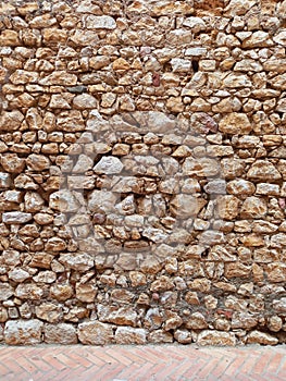 Old wall of stone and mud. Rustic stone facade. Constructions and Architecture