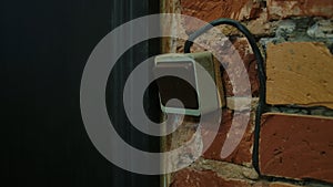 Old Wall Switch on Exposed Brick Background in Vintage Setting