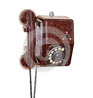 Old wall telephone with rotary dial in brown bakelite housing