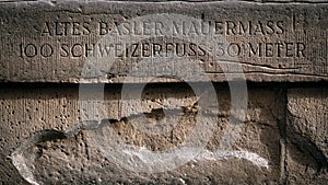 In an old wall a text that refers to old metric measurements that were common in Switzerland in the Middle Ages photo