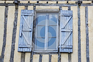 Old wall with window and open shutters