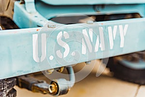 Old war vehicle license plates used as a tourist attraction with the motto US NAVI