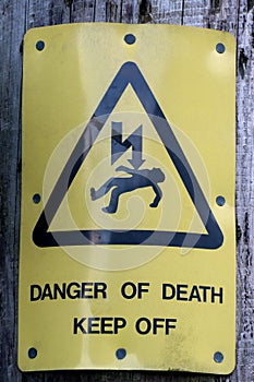 Old Warning Sign on an Electricity Pole