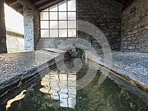 Old washhouse in the Italian village of Palanzo photo