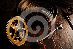 Old watch mechanism parts in the dark. Clock hands as symbol of time management