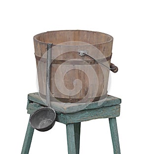 Old water bucket and dipper isolated.