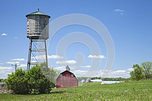 Old water cistern and red barn in rural Iowa
