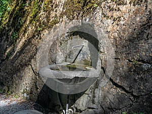 An old water fountain dug in the rock at the  bottom of the Tamina Gorge near Bad Ragaz in Switzerland - 1