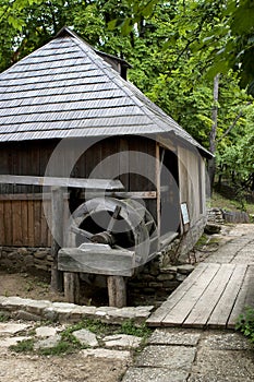 Old water mill at the edge of a forest 