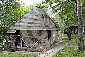 Old water mill at the edge of a forest 