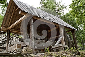 Old water mill at the edge of a forest 