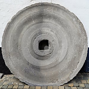 Old water mill stone as a recognition object for historical building