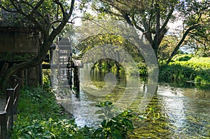 Old water mill, water wheel on a river in countryside